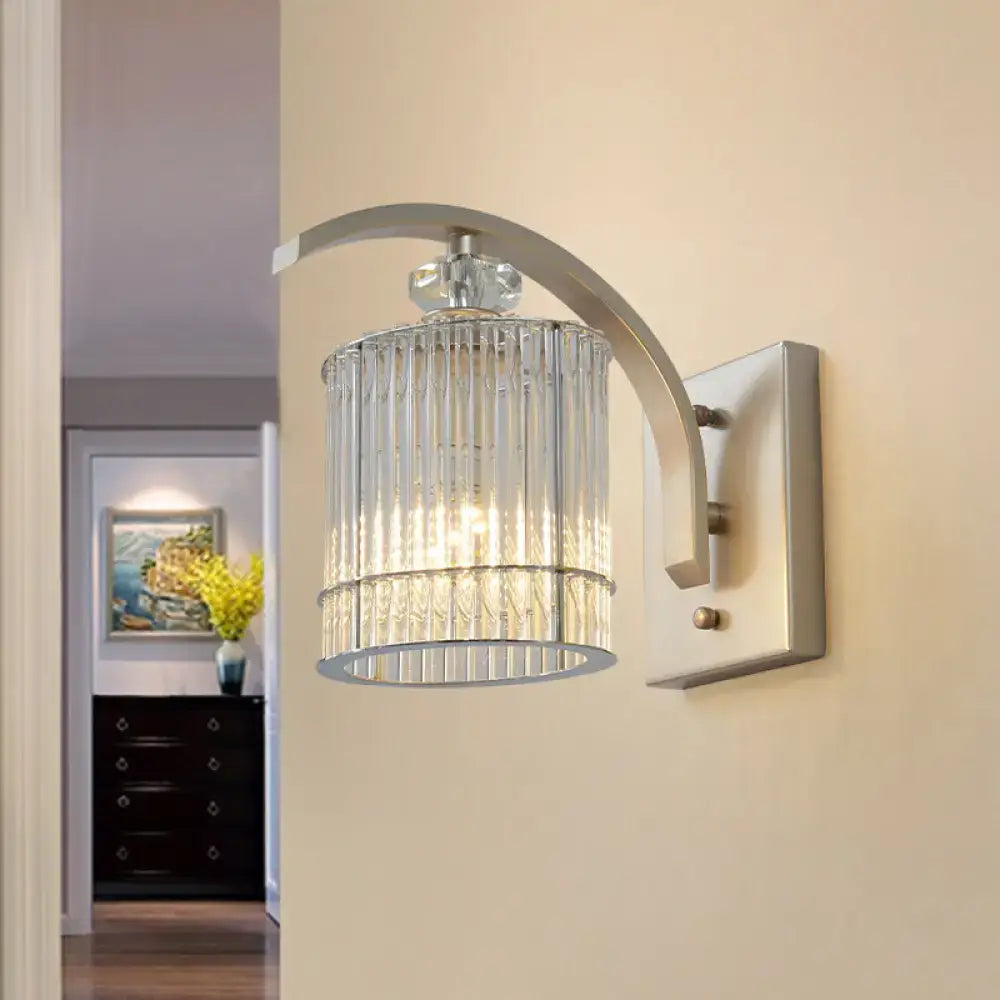 Modern gold wall mounted lamp with clear crystal shade and curved metallic arm for bedroom lighting