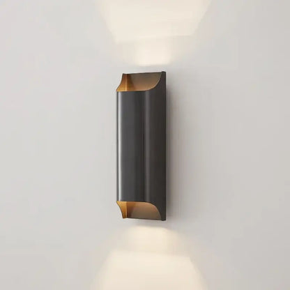 Modern black and gold wall sconce with sleek curved design, a minimalist wall lamp from decorbites copper brass collection