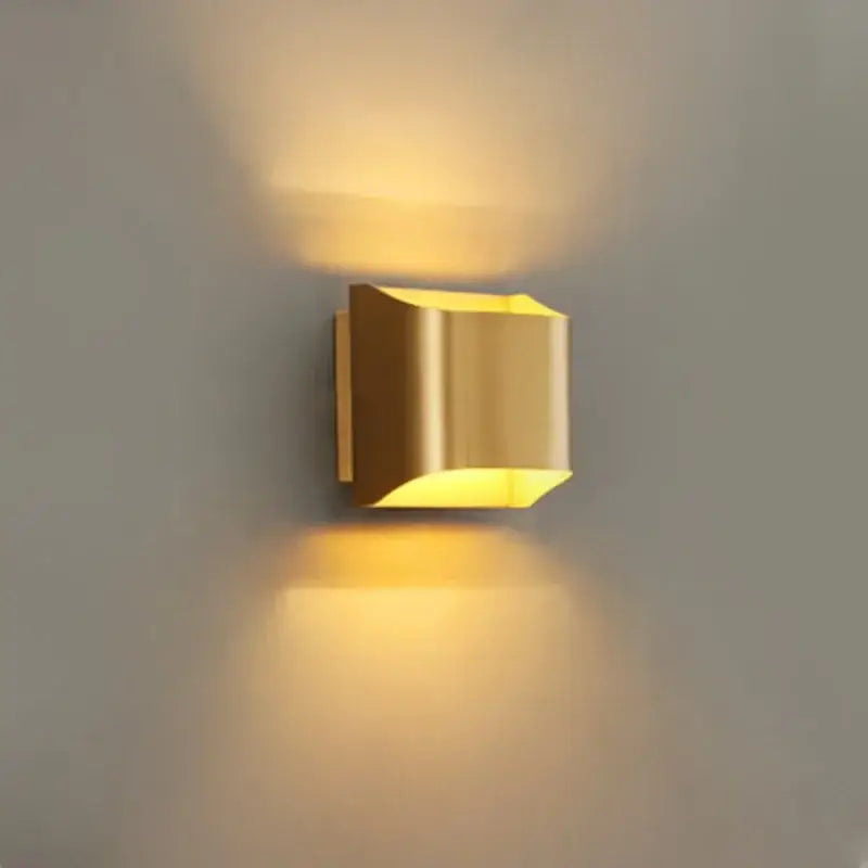 Modern gold wall sconce with sleek metallic finish in copper brass ideal for minimalist living room wall lamp decorbites style