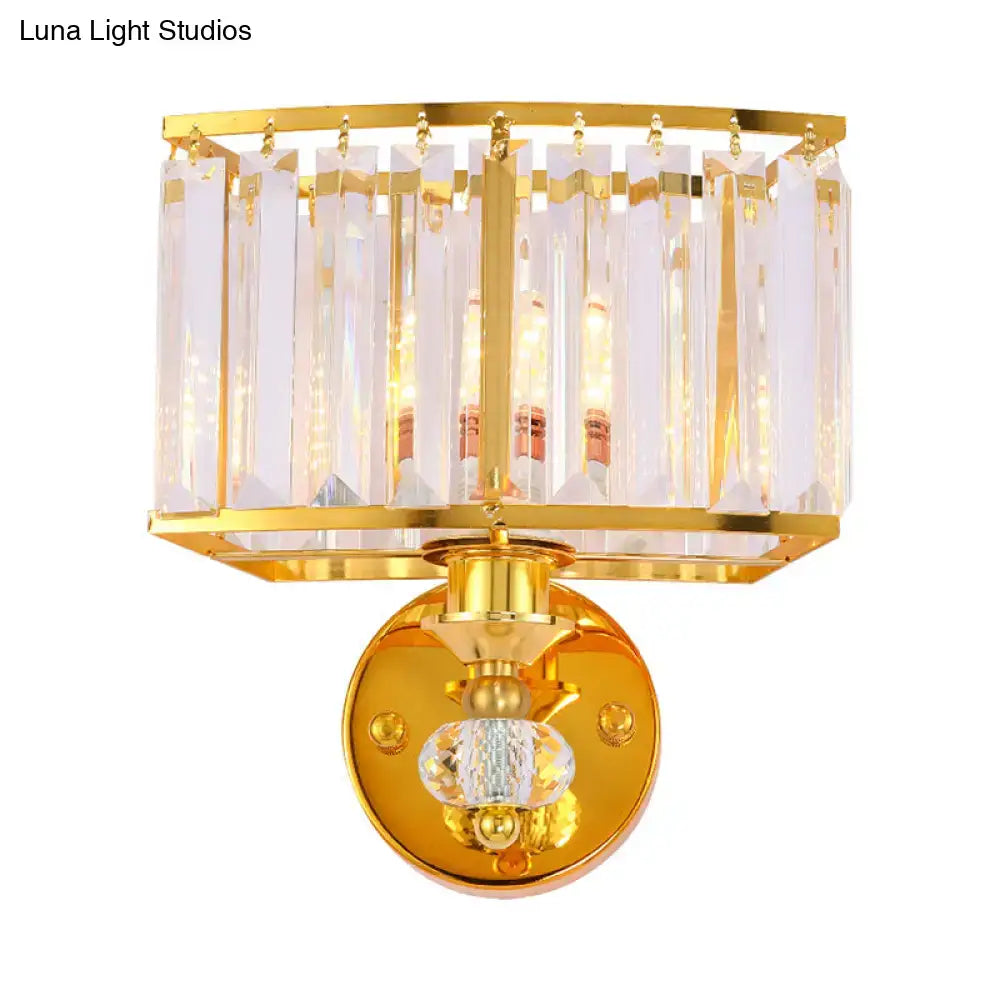 Modern gold wall sconce featuring clear crystal block vertical prisms and a central faceted clear crystal orb for bedroom lighting