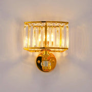 Modern gold wall sconce with vertical clear crystal rods and a central crystal block for bedroom lighting