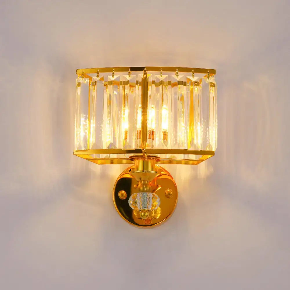Modern gold wall sconce with vertical clear crystal rods and a central crystal block for bedroom lighting