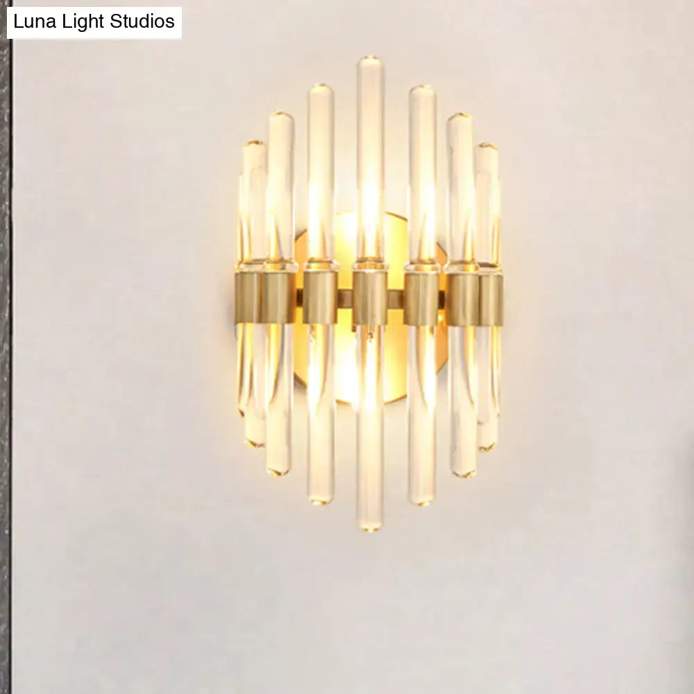 Modern gold wall sconce with clear crystal rods and gold-toned metal accents for stylish living room lighting