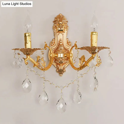 Modern gold wall sconce with crystal drops features two candle-style e12 e14 arms for elegant bedroom lighting