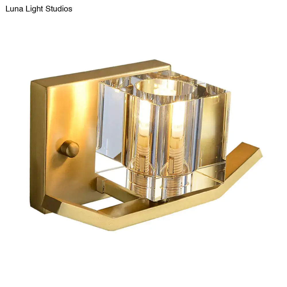 Modern gold wall sconce featuring a faceted cubic clear crystal shade for elegant parlor lighting