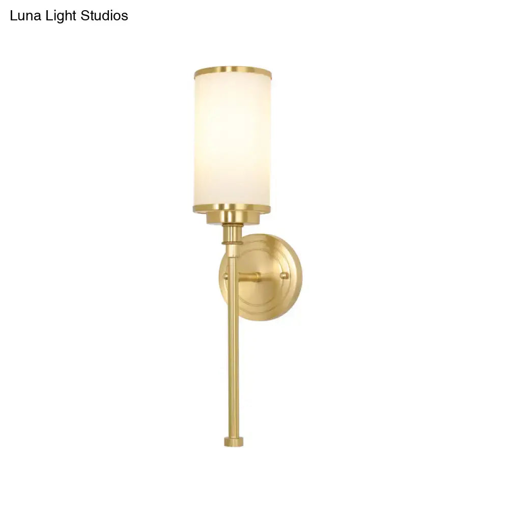 Modern gold wall sconce with a brushed brass finish and milky glass shade 12 inch fixture for living room lighting