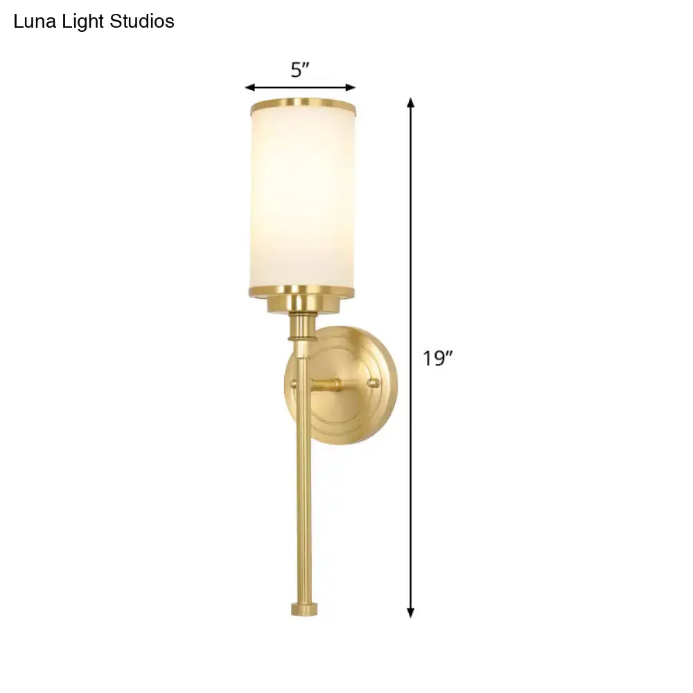 Modern gold wall sconce with milky glass cylindrical shade in brushed brass finish for living room 10 inch fixture