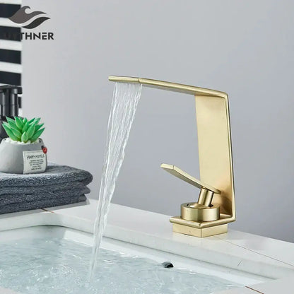 Modern gold waterfall basin faucet with brushed metal finish and sleek design by decorbites basin faucet for bathrooms