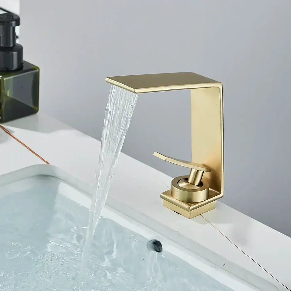 Modern gold waterfall basin faucet with brushed metal finish and sleek design by decorbites for bathroom use