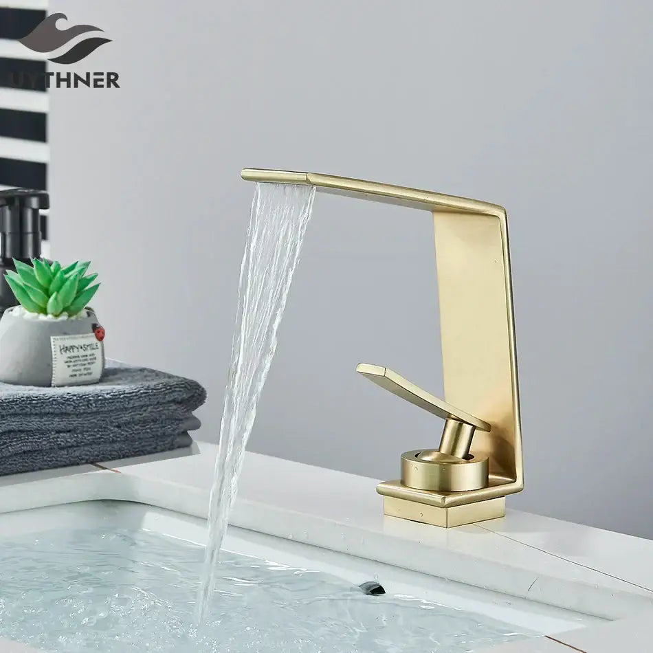 Modern gold waterfall basin faucet with brushed metal finish and sleek design from decorbites basin faucet collection