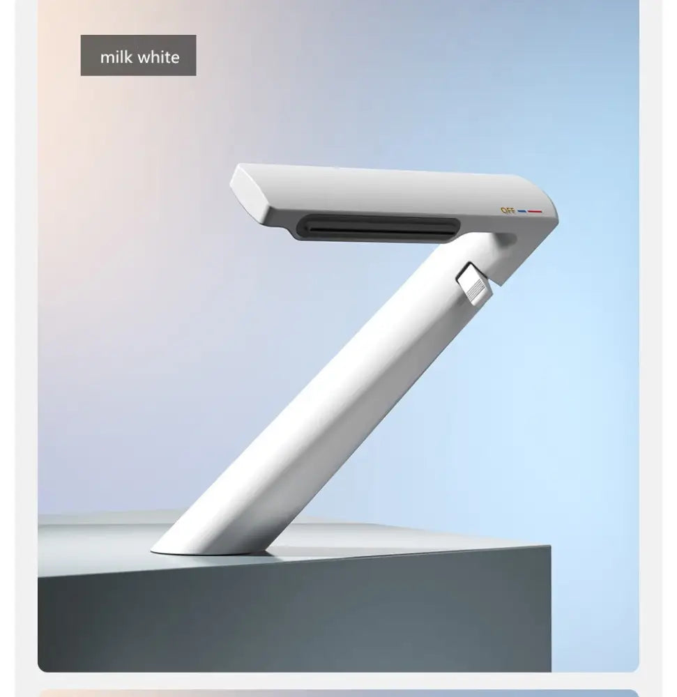 Milk white sleek desk lamp with minimalist design and smooth curves displayed with decorbites gold waterfall basin faucet