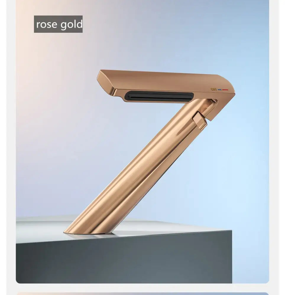 Rose gold foldable hair straightener with sleek metallic finish complements decorbites gold waterfall basin faucet design
