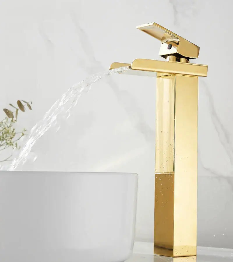 Modern gold waterfall basin faucet with gold-toned rectangular design and sleek waterfall spout by decorbites
