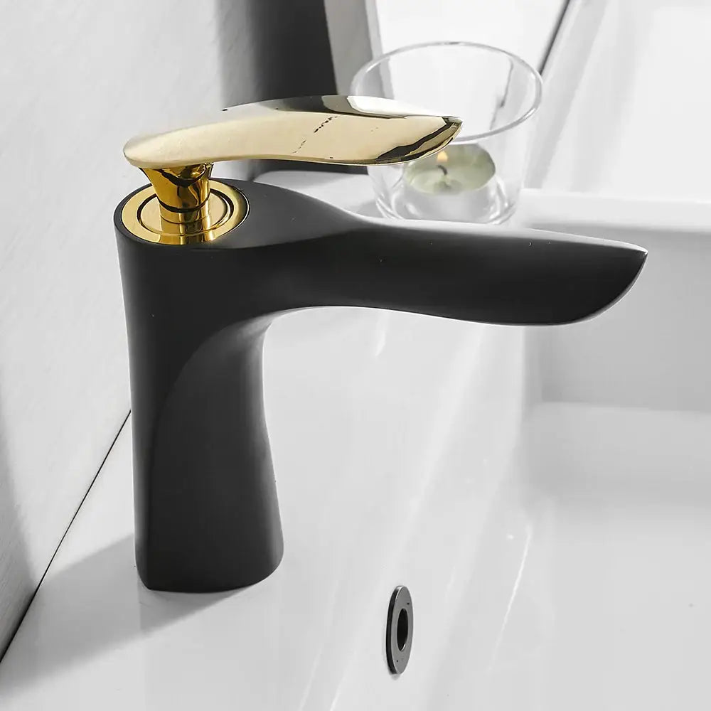 Modern gold waterfall bathroom faucet featuring a black matte body with a polished gold-tone handle decorbites gold waterfall