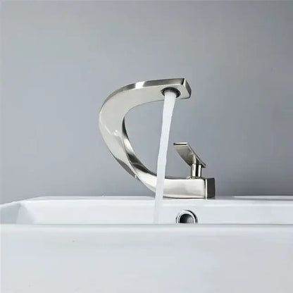 Modern gold waterfall mixer bathroom faucet with sleek curved design and single handle in brushed stainless steel