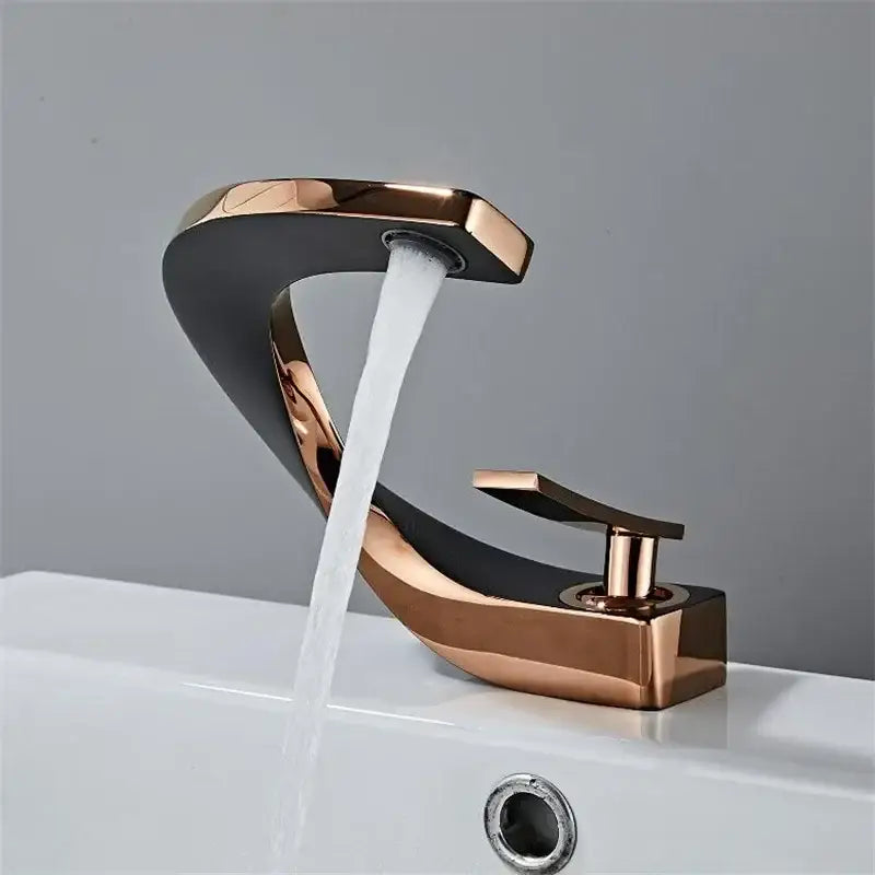 Modern gold waterfall bathroom faucet with rose gold and black finish featuring a sleek curved design