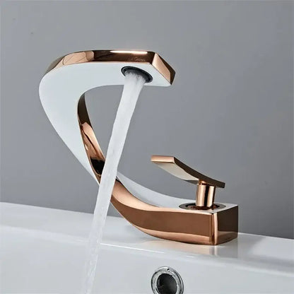 Modern gold waterfall mixer bathroom faucet in rose gold with sleek curved design and flowing water stream