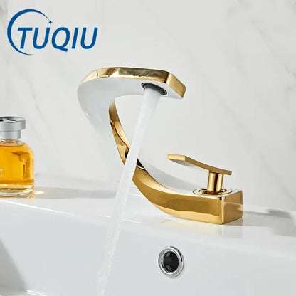 Modern gold waterfall mixer bathroom faucet with a gold-toned polished finish and sleek curved design