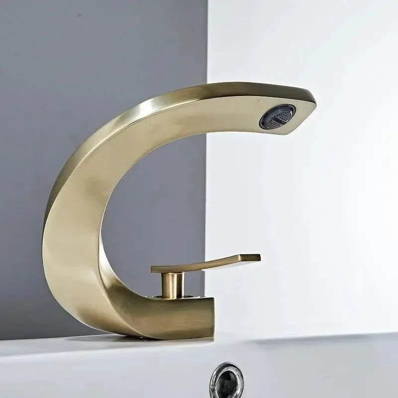 Modern gold waterfall mixer bathroom faucet with sleek curved design and brushed metal finish