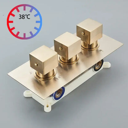 Modern gold waterfall shower faucet set with brass-finished square top valve trim and three control knobs on metallic plate