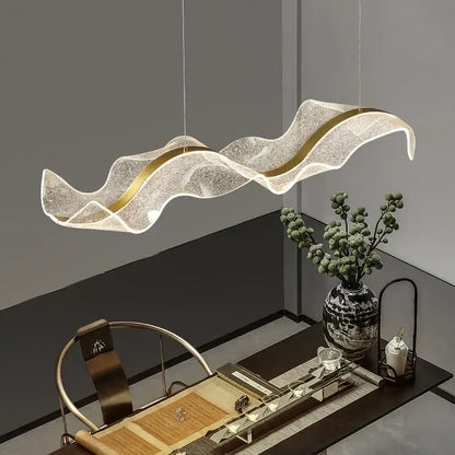 Modern gold wave design acrylic pendant light with translucent glittering white body and gold wave trim for living room