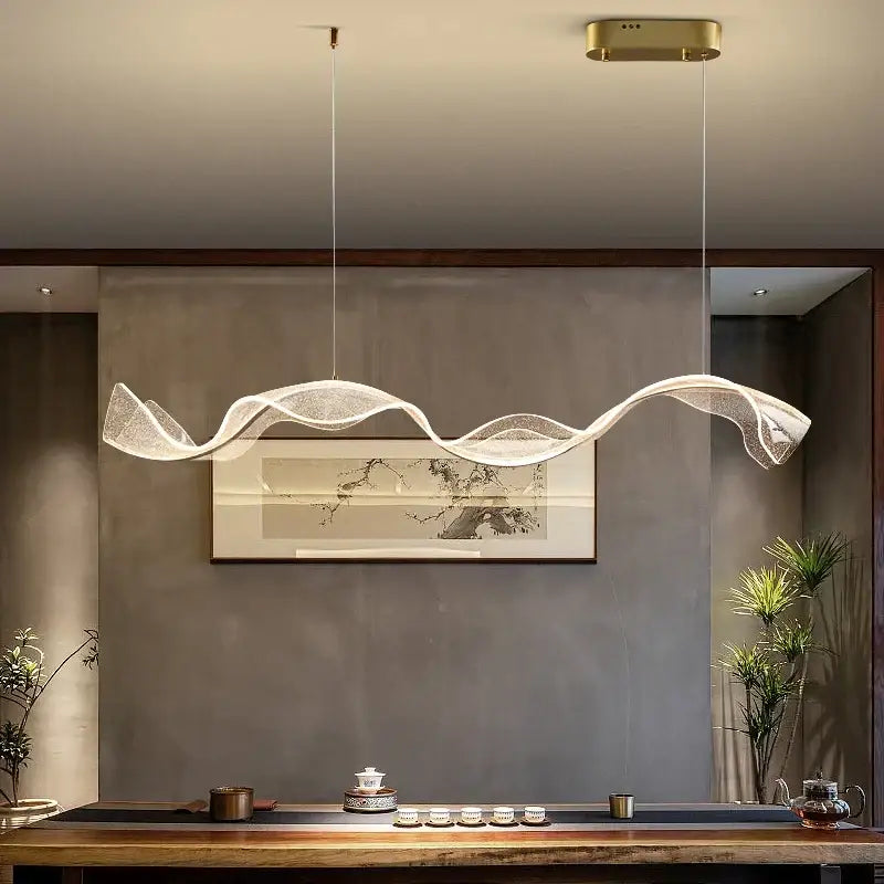 Modern gold wave design acrylic pendant light featuring a translucent mesh and gold wave ceiling fixture for living room