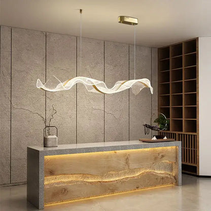 Modern gold wave design acrylic pendant light featuring a translucent flowing wave shape for living room use