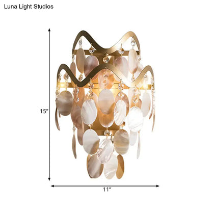 Modern gold wave wired electric wall sconce with cream and gold shell accent and dangling crystal beads