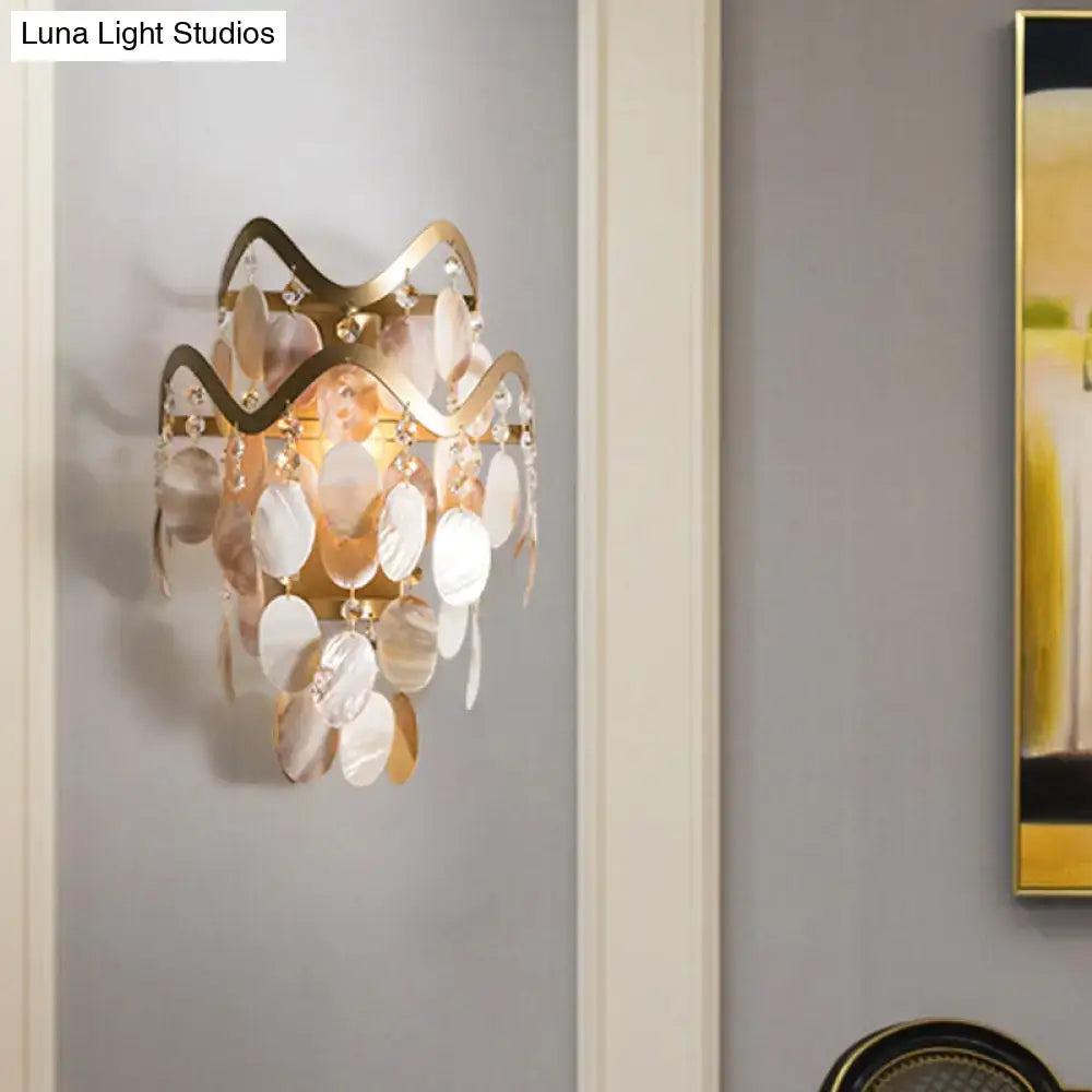 Modern gold wave sconce with shell accent featuring cascading mother-of-pearl and crystal discs direct wired electric