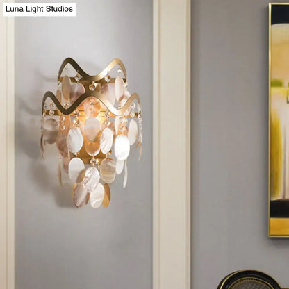 Modern gold wave sconce with shell accent featuring cascading mother-of-pearl and crystal discs direct wired electric