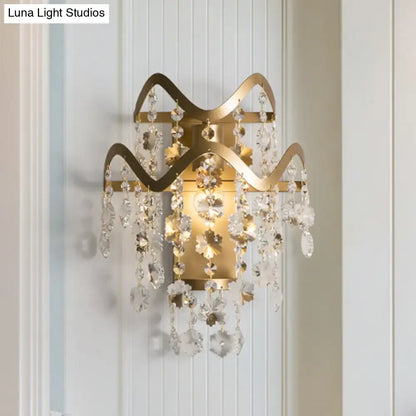 Modern gold wave sconce with shell accent featuring gold-toned direct wired electric light and cascading crystal droplets