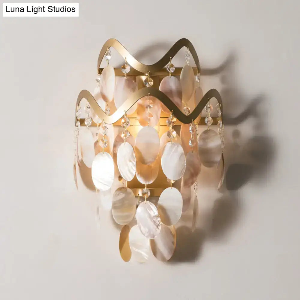 Modern gold wave sconce with shell accent featuring layered mother-of-pearl shells and wired electric direct wired design
