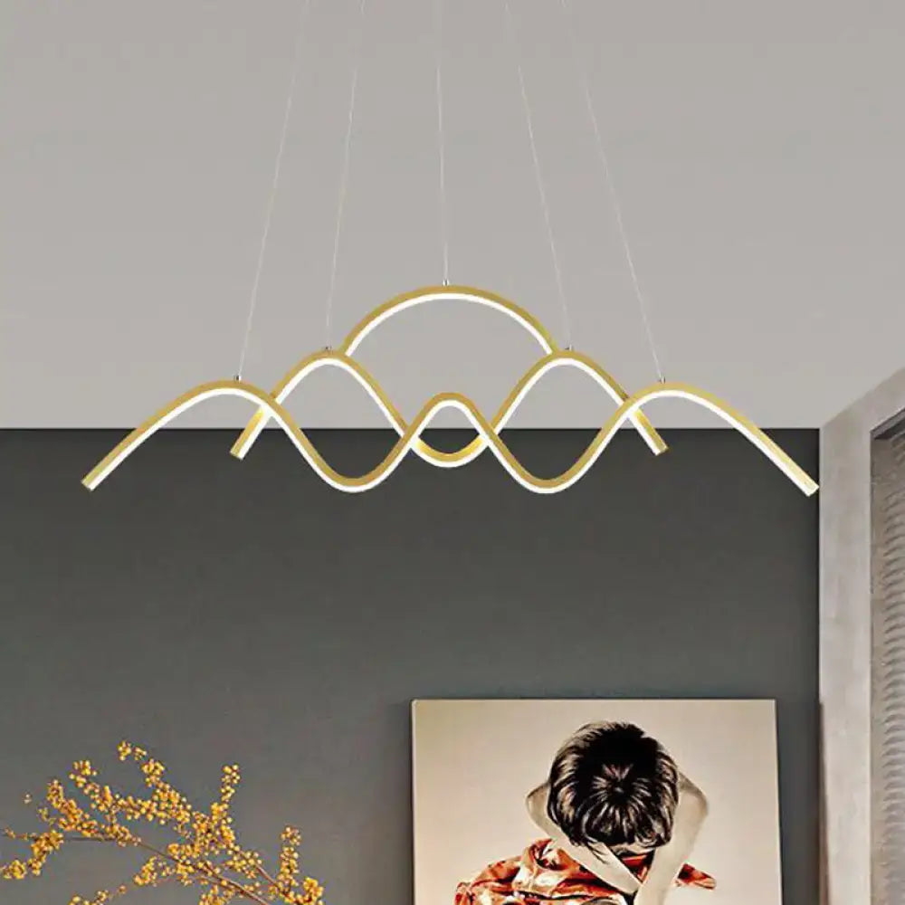 Modern gold-toned led chandelier by DecorBites with wave-like mountain design featuring warm white light