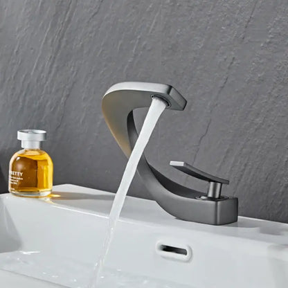 Modern matte black bathroom faucet with sleek curved spout and flowing water for decorbites gold white bathroom basin decor