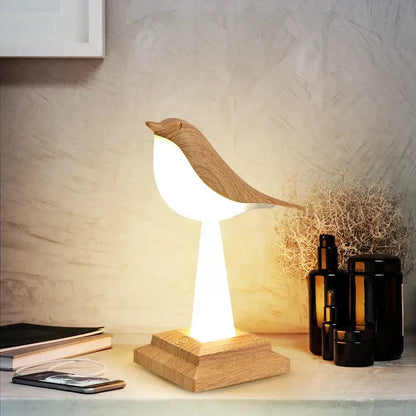 Modern gold and white wooden bird table lamp with warm glowing light and natural wood grain finish for desk decorbites bird table