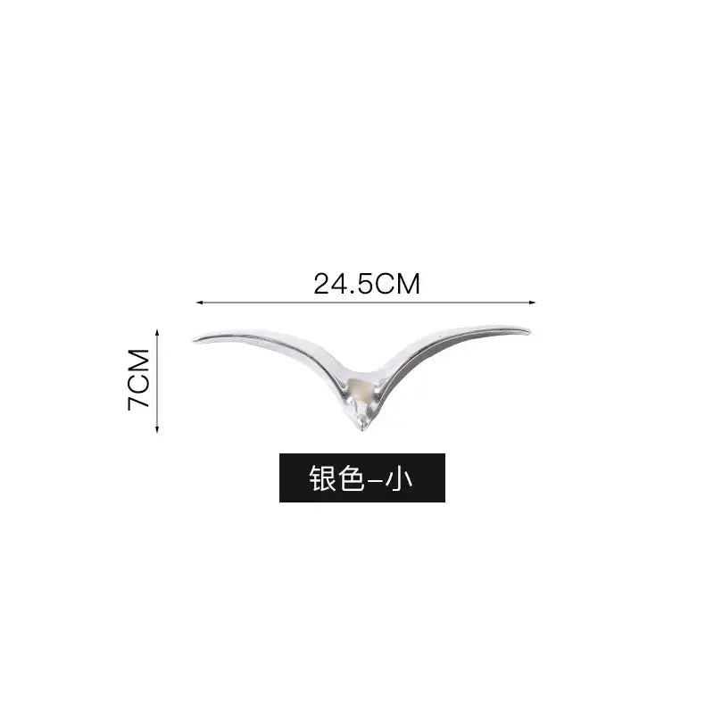 Silver-colored sleek bird-shaped car ornament with polished metallic finish complementing ceramic pendant wall decor