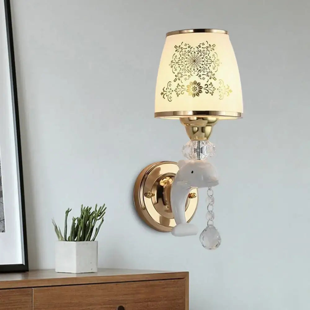 Modern gold and white dolphin wall sconce with opal glass shade and crystal beads for elegant bedroom lighting