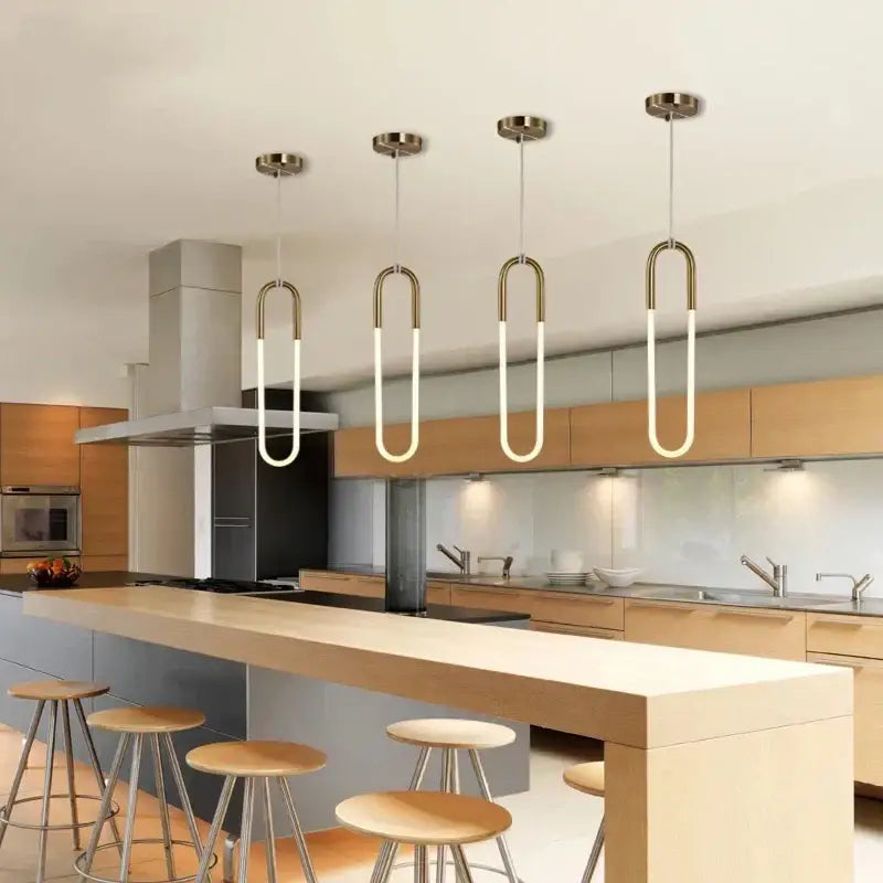 Four modern gold pendant lights with curved brass frames and white led tubes for living room or kitchen decorbites decor