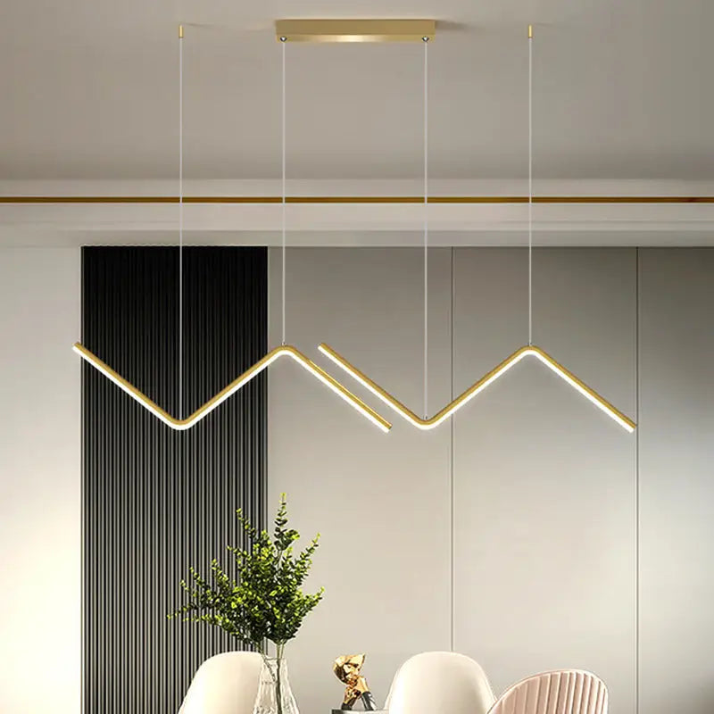 Modern gold-toned zigzag pendant lighting fixture in metal with sleek minimalist design for dining room lighting