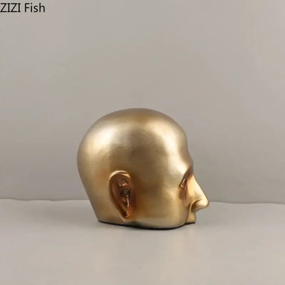 Modern golden abstract resin sculpture of a bald human head in profile with smooth contours for office decorbites decor