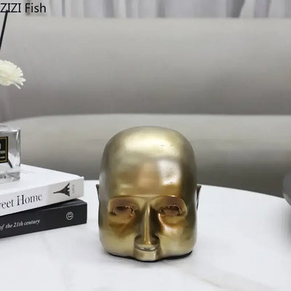 Modern golden abstract resin sculpture of a bald human head with smooth reflective surface for office desk decorbites abstract resin ornament