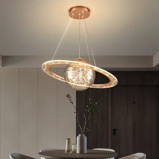 Modern golden acrylic led chandelier with a spherical glass globe and glowing copper rings planet pendant light decorbites