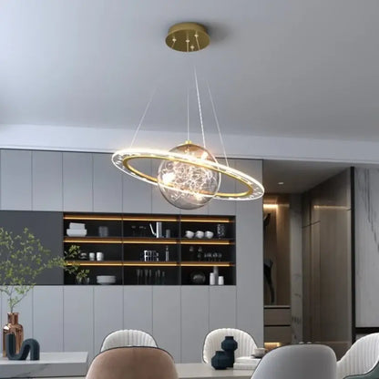 Modern golden acrylic led chandelier bedroom planet pendant light with clear glass sphere and glowing ring decorbites golden acrylic