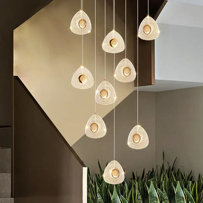 A set of modern golden acrylic led chandeliers with teardrop crystal pendants and warm golden centers for living room decorbites golden acrylic