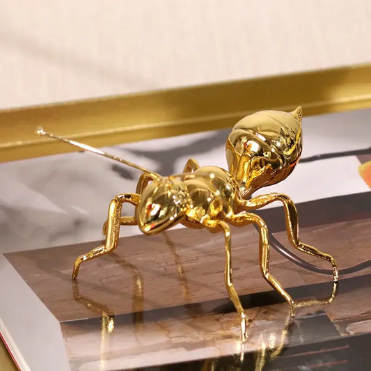 Shiny gold ant metal sculpture with detailed segmented body and articulated legs modern golden ant metal decorbites ornament