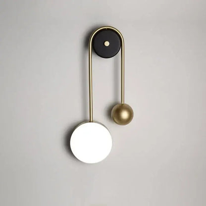 Modern brass wall lamp with sleek curved arm black accent and glowing white disc base for bedroom decorbites golden ball led