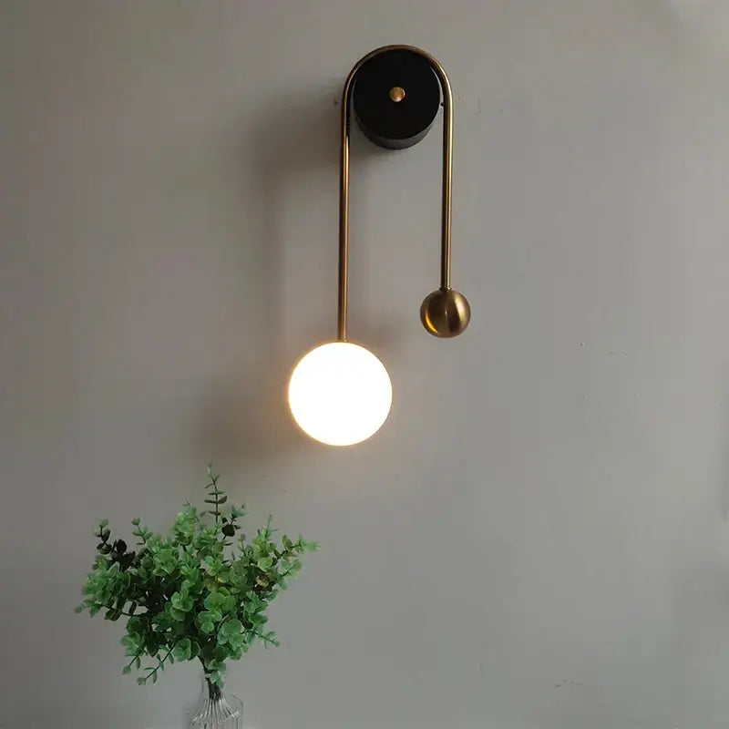 Modern brass wall lamp with decorbites golden ball led design featuring a warm glowing spherical accent for bedroom decor