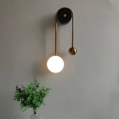 Modern brass wall lamp with decorbites golden ball led design featuring a warm glowing spherical accent for bedroom decor