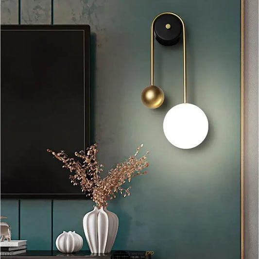 Modern wall lamp with decorbites golden ball led design features sleek gold metal frame and white and gold spherical shades