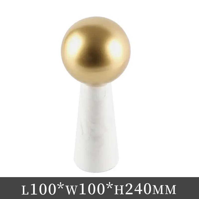 Gold-colored spherical knob mounted on a white marble cone base modern golden ball living room ornament spherical ornaments